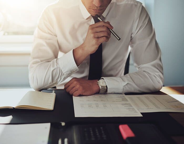 man sitting at desk thinking