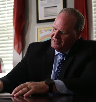 Jonathan E. Fortman ("Jon") sitting at desk, writing