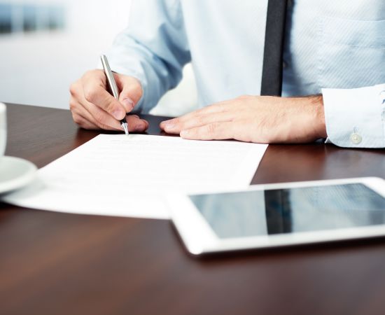 Man Signing Document