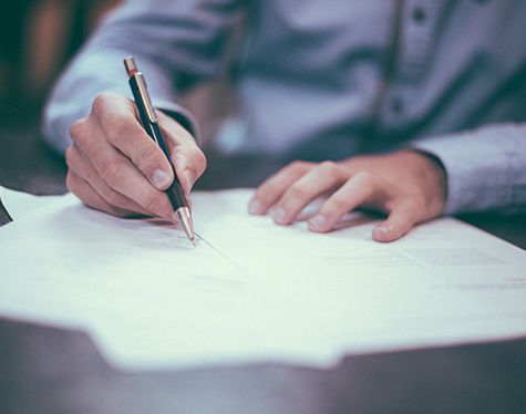 man signing documents