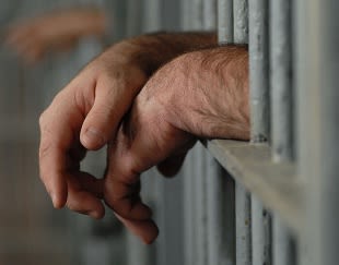 hands through jail bars