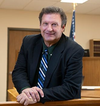 Dale standing in the courtroom smiling