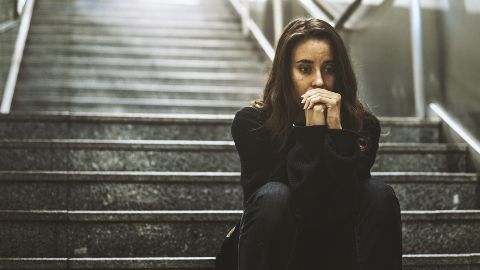 Distressed woman on stairs