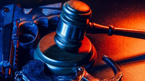 Gun, gavel, and handcuffs