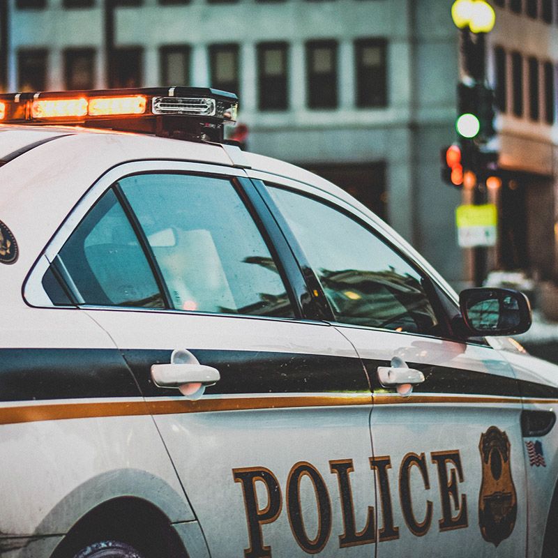 Police car sitting in traffic with it's lights on
