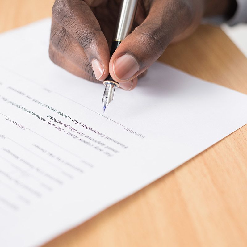 Man filling out a contract
