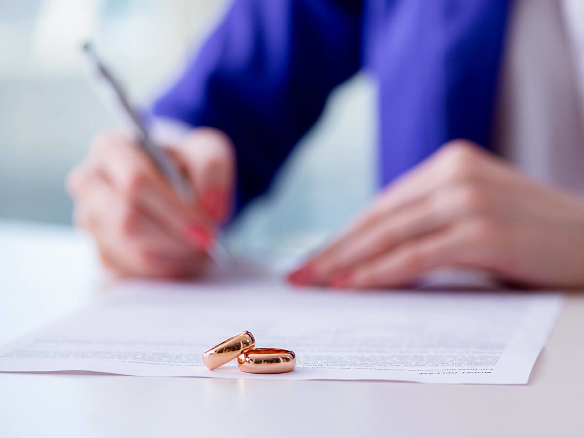 Woman signing a prenuptial agreement