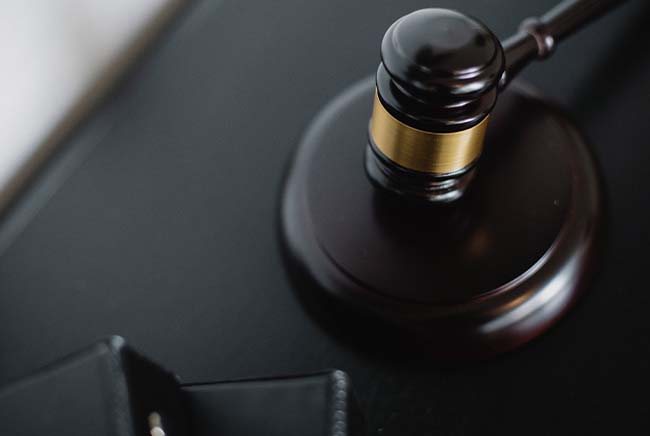 gavel sitting on a table with files