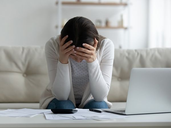 Woman in distress with her head in her hands