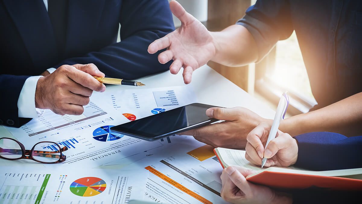 A group of business people meeting and discussing charts