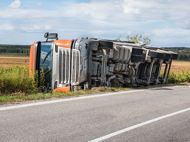 Semi-truck overturned on the side of the road