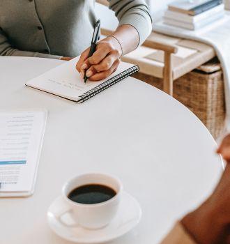 People working at a table with coffee